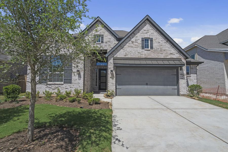 Front exterior of a new home in Jordan Ranch 55's, Fulshear, TX, highlighting curb appeal (Image 2). Front exterior of a new home in Jordan Ranch 55's, Fulshear, TX, highlighting curb appeal (Image 2).