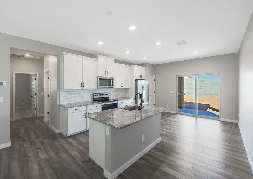 Upgraded kitchen with designer finishes, including a beautiful backsplash and granite countertops.