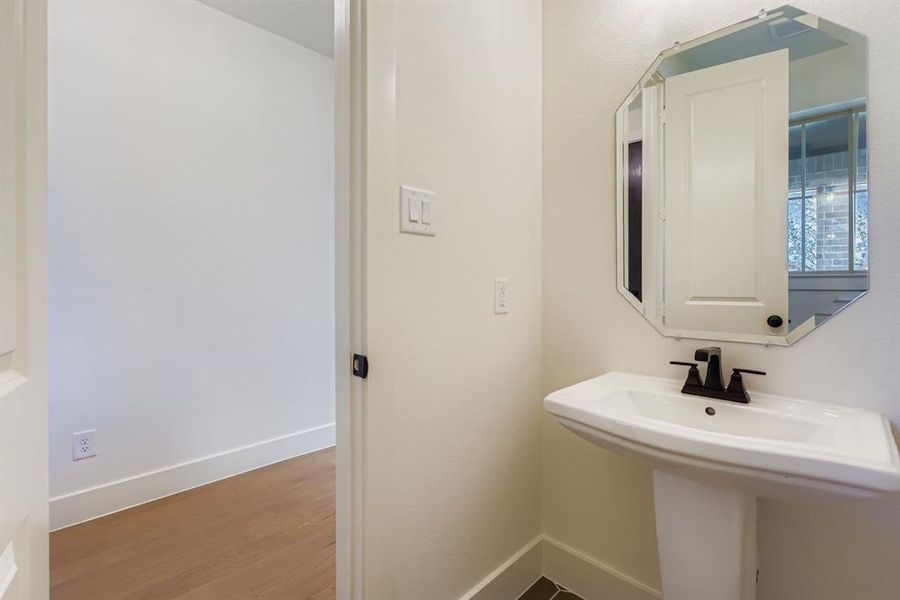 Bathroom with baseboards and wood finished floors