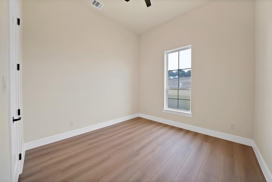 Spare room featuring light wood-style flooring and ceiling fan Spare room featuring light wood-style flooring and ceiling fan