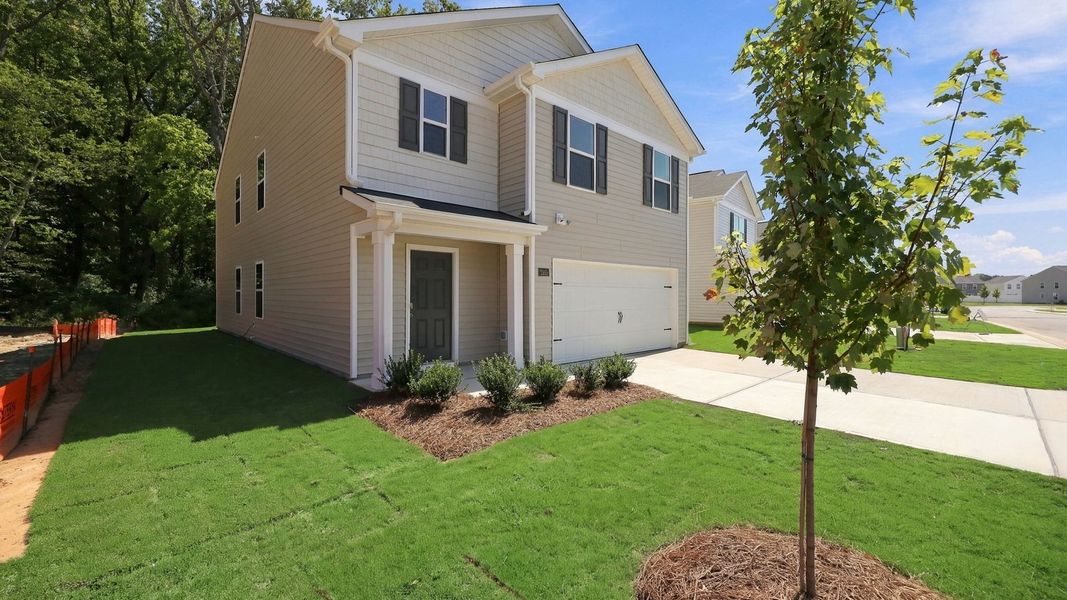 Front exterior of a new home in Carter Ridge, Greenville, NC, highlighting curb appeal (Image 16). Front exterior of a new home in Carter Ridge, Greenville, NC, highlighting curb appeal (Image 16).