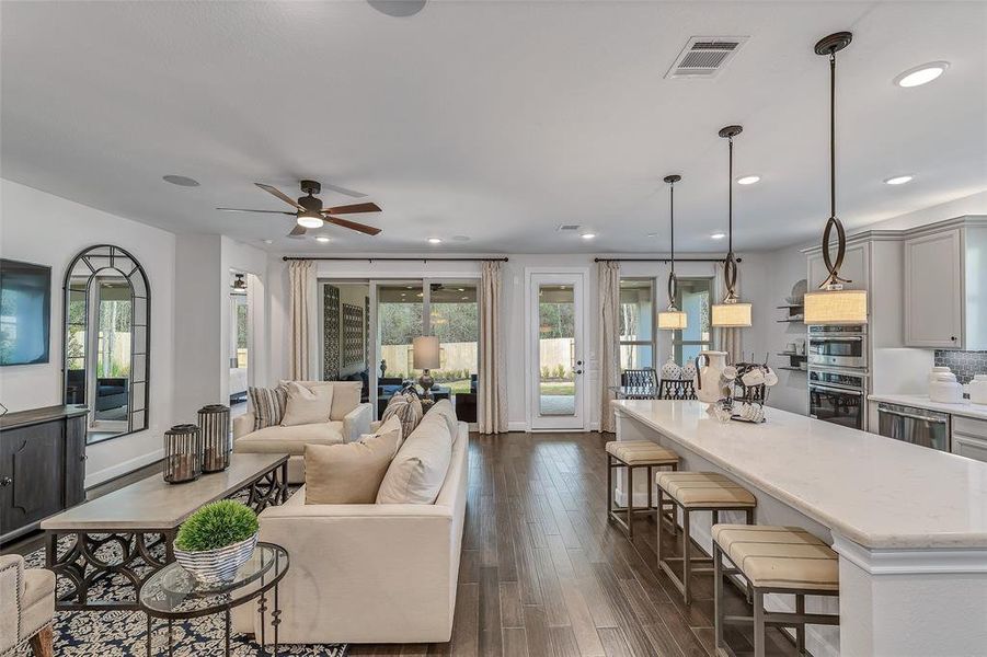 Representative Photo. Flowing views of the family room and kitchen that tie into one another seamlessly