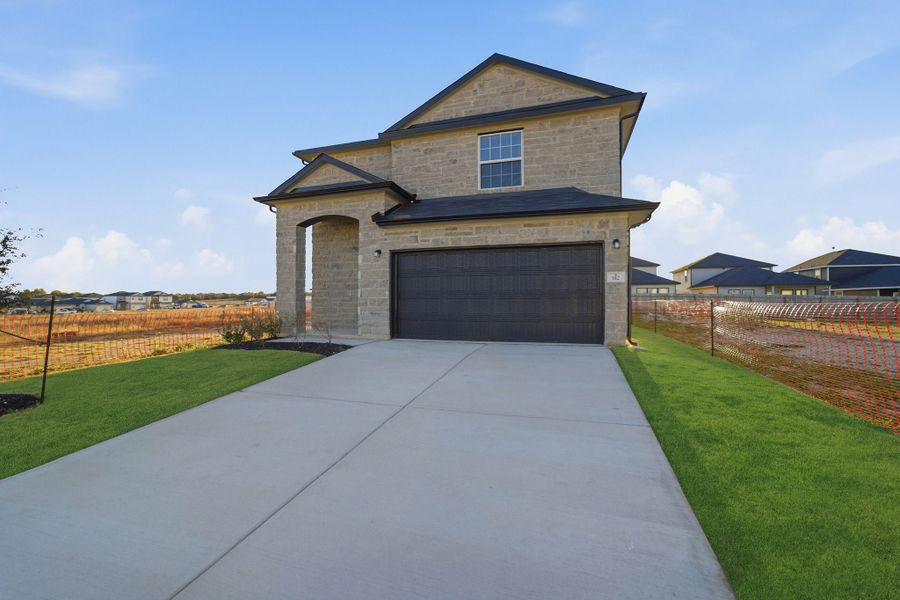 Front exterior of a new home in Cool Water, Jarrell, TX, highlighting curb appeal (Image 26). Front exterior of a new home in Cool Water, Jarrell, TX, highlighting curb appeal (Image 26).