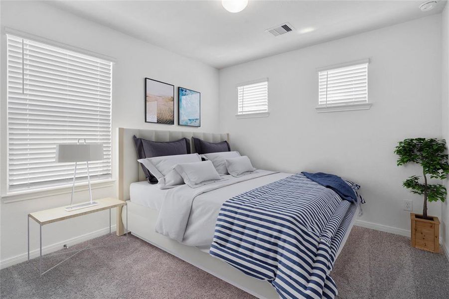 Secondary bedroom features plush carpet, neutral paint, lighting, large window with privacy blinds and ample sized closet space.