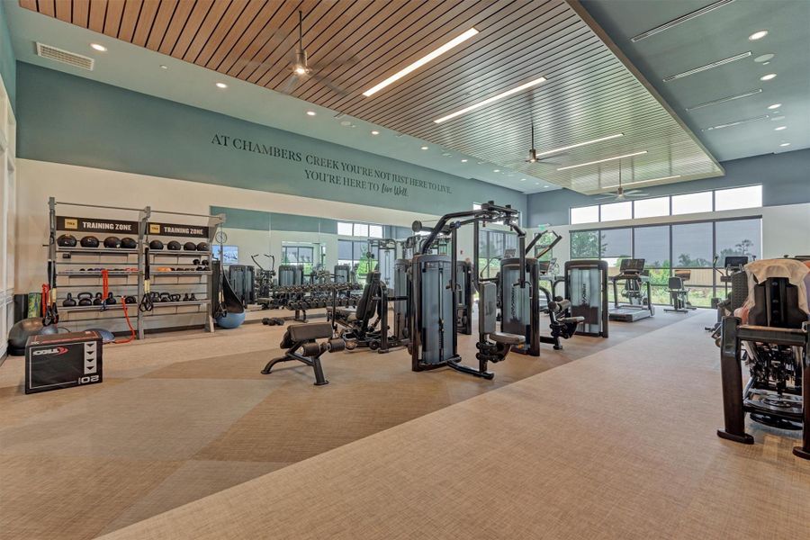 The fitness room offers cardio and weight equipment in a clean and organized environment.
