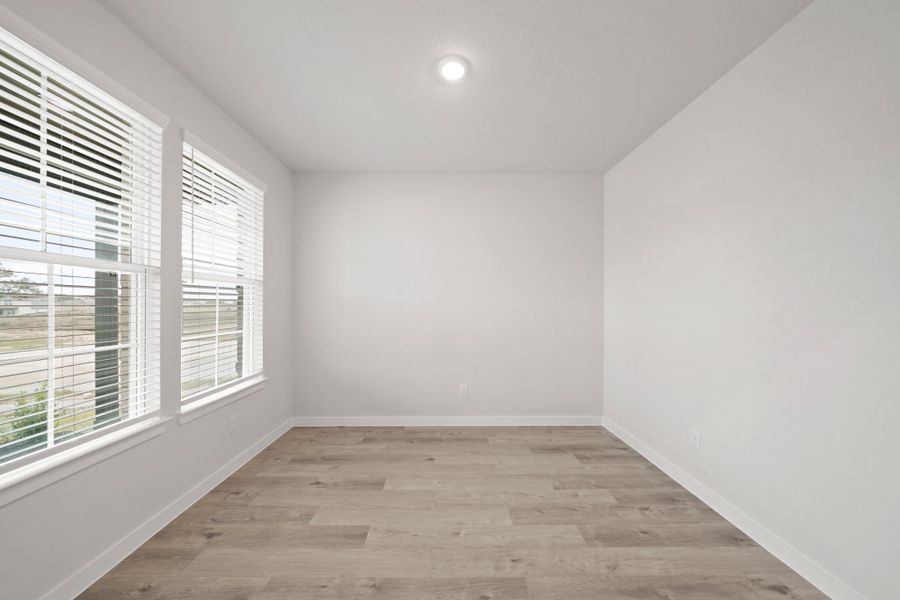 A room with windows and a wood floor. A room with windows and a wood floor.