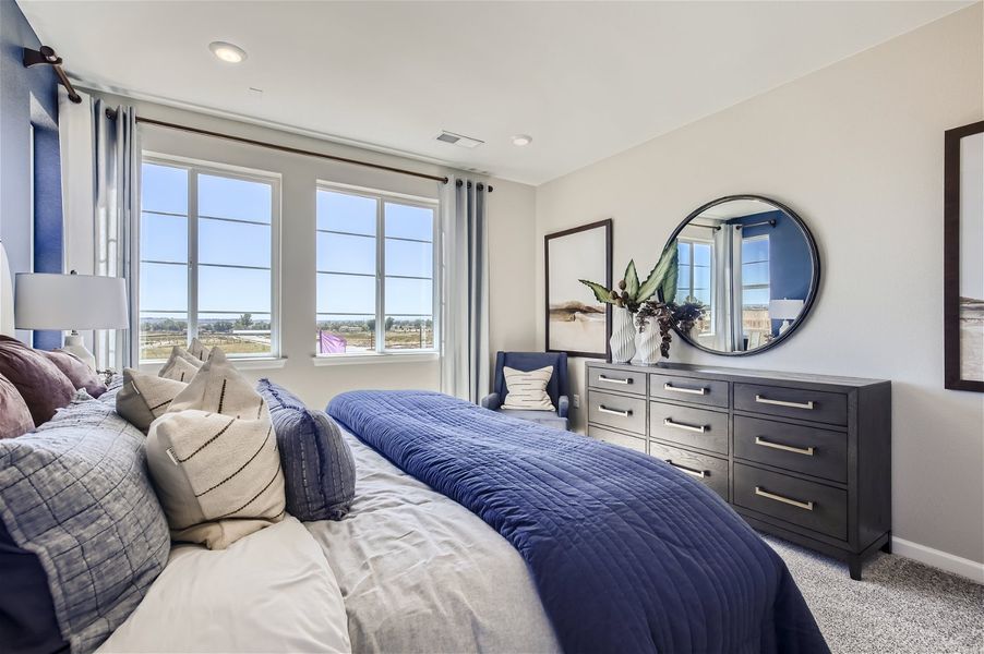 A bedroom with a large mirror. A bedroom with a large mirror.