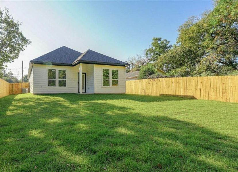 Rear view of property with a fenced backyard and roof with shingles Rear view of property with a fenced backyard and roof with shingles