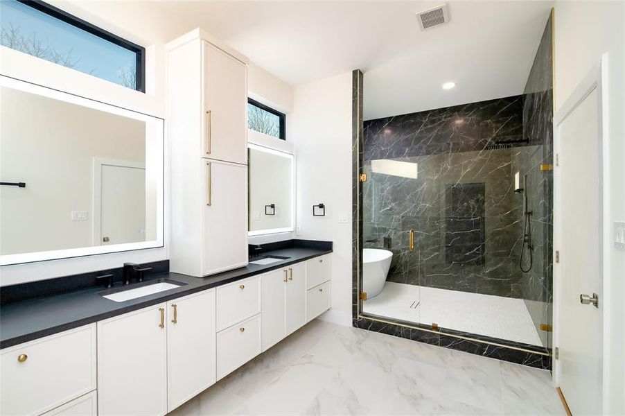 Bathroom featuring vanity and independent shower and bath