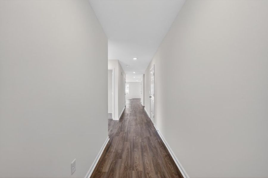 A long hallway with white walls.