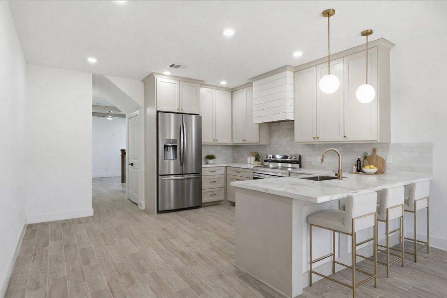 The kitchen offers a walk-in pantry, quartz countertops, stainless steel appliances—including a stove and dishwasher—and a convenient nook for your microwave.