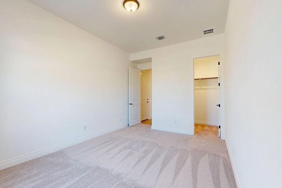 This interior space features light-colored walls and carpeting, with a ceiling-mounted light fixture