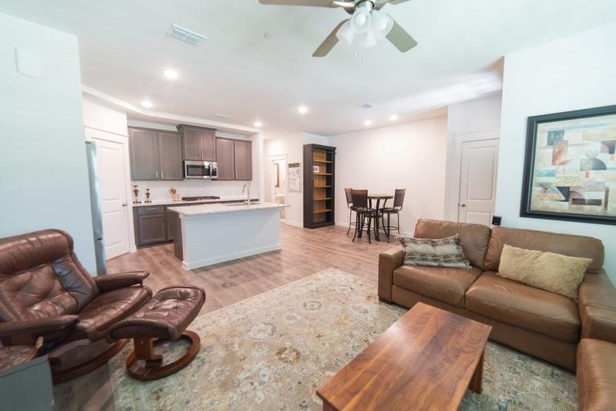 Living area featuring recessed lighting, light wood-type flooring, and a ceiling fan