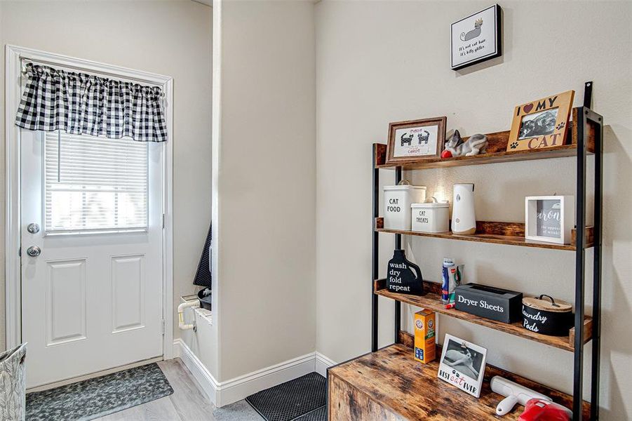 Doorway to outside with light wood-type flooring