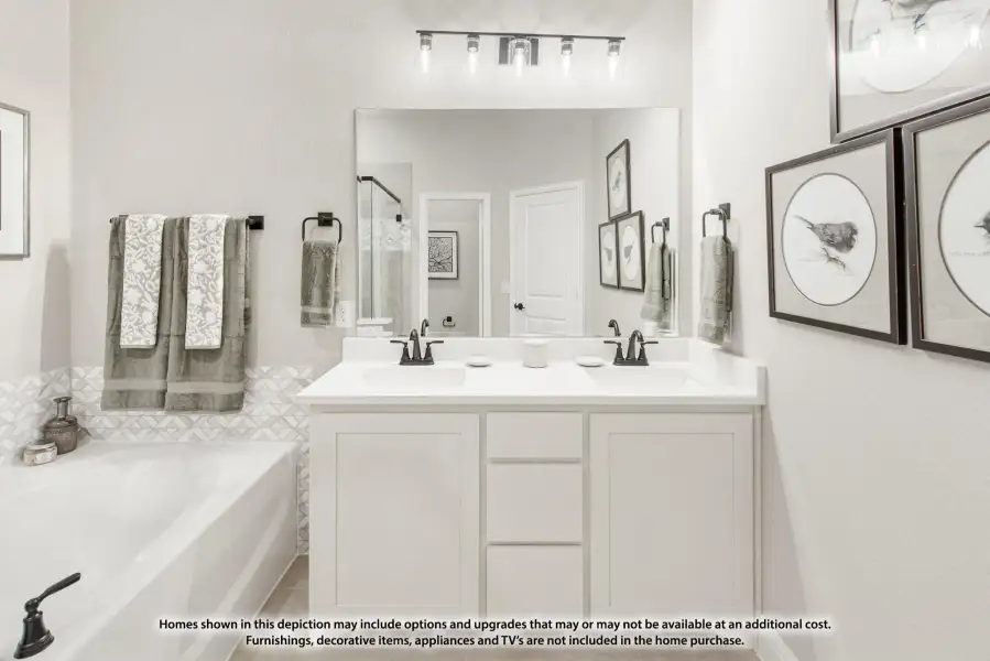 Bathroom with double-sink white vanity, large mirror, soaking tub, and geometric tile accent wall