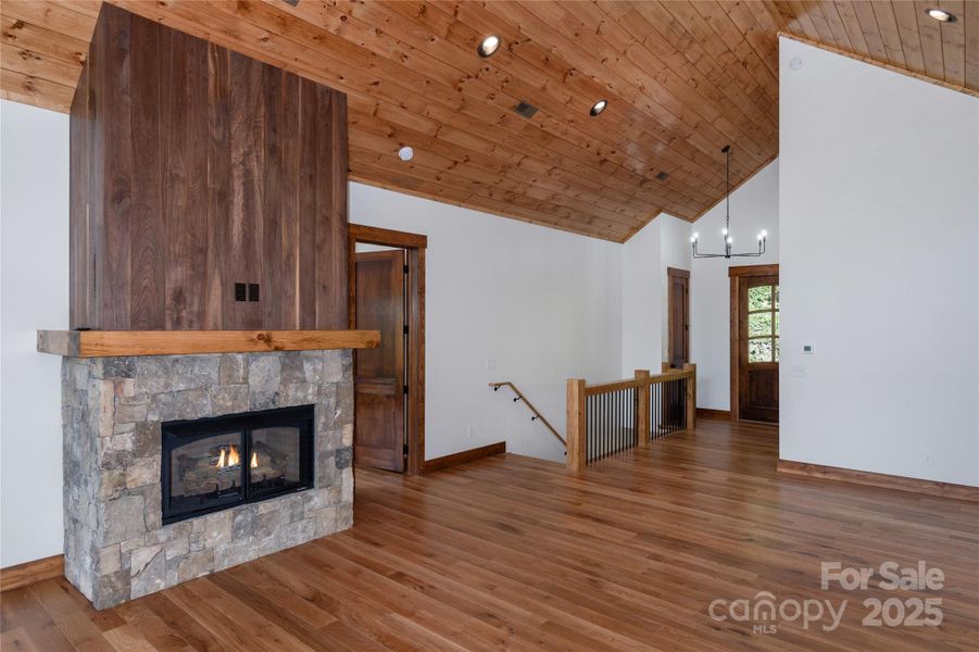 Vaulted living room with floor to ceiling sliding doors & windows and gas fireplace