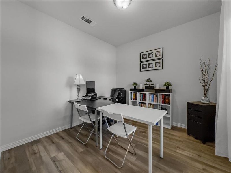 Office with light hardwood / wood-style floors