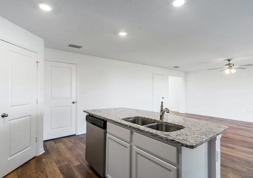 The kitchen island overlooks the entertainment space