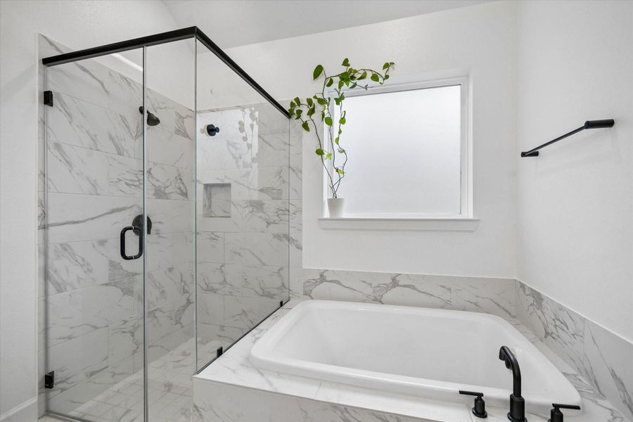 elax and unwind in the luxurious soaking tub perfectly positioned beside the oversized glass-enclosed shower, creating a serene spa-inspired atmosphere. elax and unwind in the luxurious soaking tub perfectly positioned beside the oversized glass-enclosed shower, creating a serene spa-inspired atmosphere.