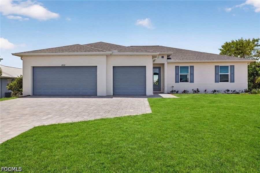 Front exterior of a new home in Cape Coral, Cape Coral, FL, highlighting curb appeal (Image 1). Front exterior of a new home in Cape Coral, Cape Coral, FL, highlighting curb appeal (Image 1).