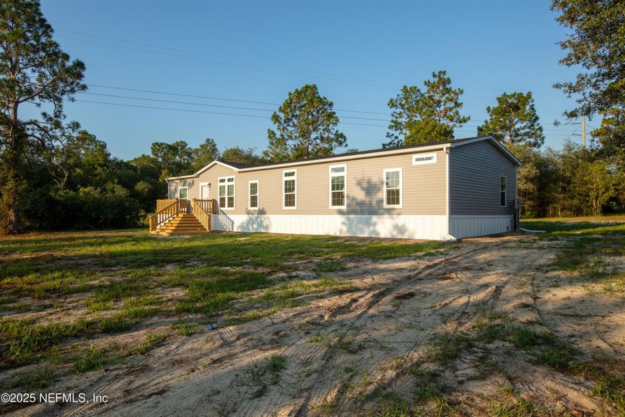 Front exterior of a new home in , Keystone Heights, FL, highlighting curb appeal (Image 26). Front exterior of a new home in , Keystone Heights, FL, highlighting curb appeal (Image 26).