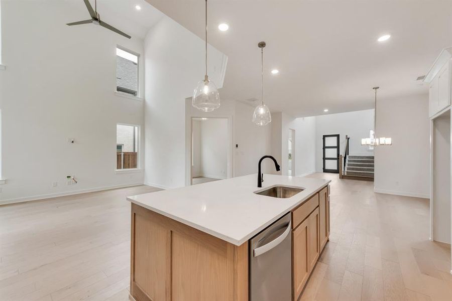 Kitchen with open floor plan, light wood-style floors, a center island with sink, dishwasher, and recessed lighting Kitchen with open floor plan, light wood-style floors, a center island with sink, dishwasher, and recessed lighting