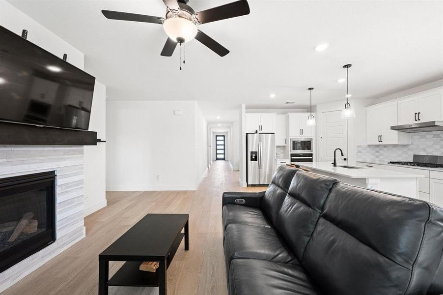 Open-concept living area with light wood-finish flooring Open-concept living area with light wood-finish flooring
