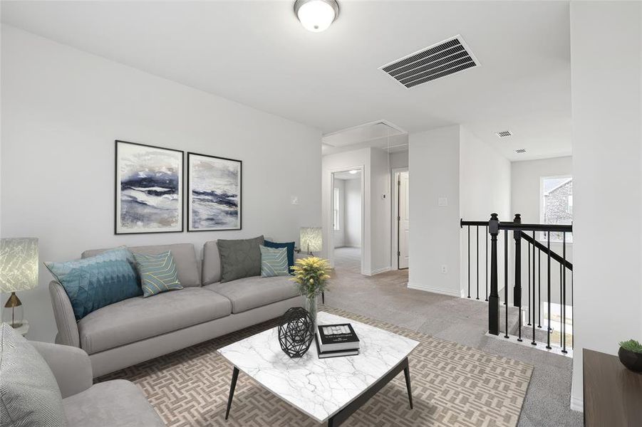 Living area featuring attic access, carpet flooring, and baseboards