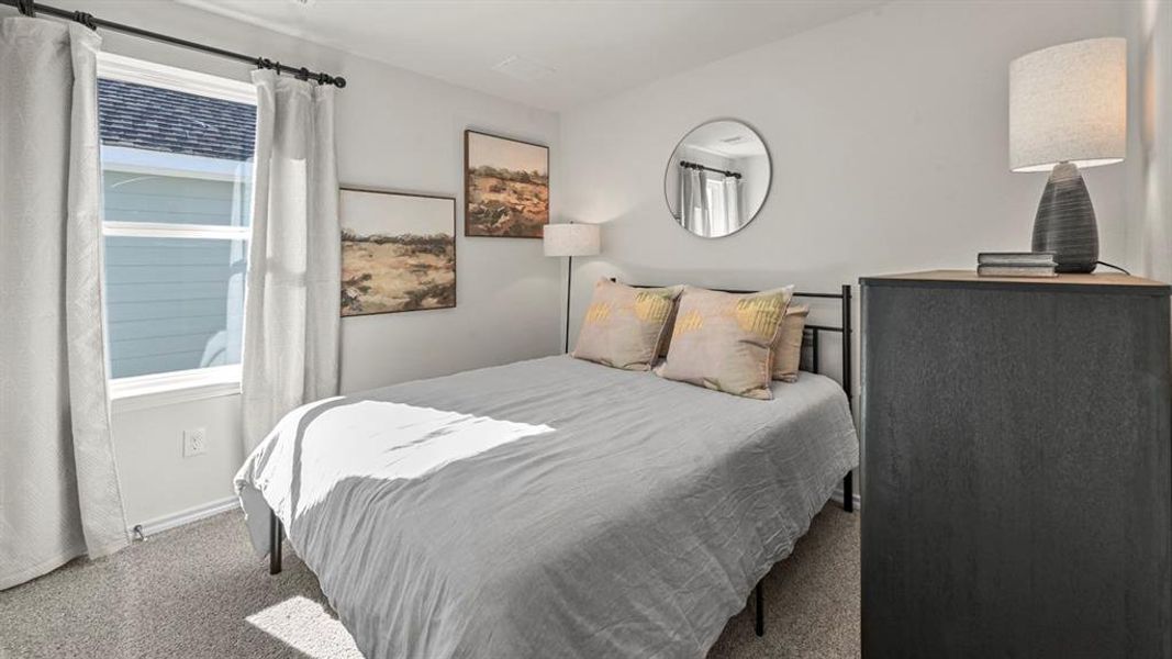 Bedroom with carpet floors and baseboards