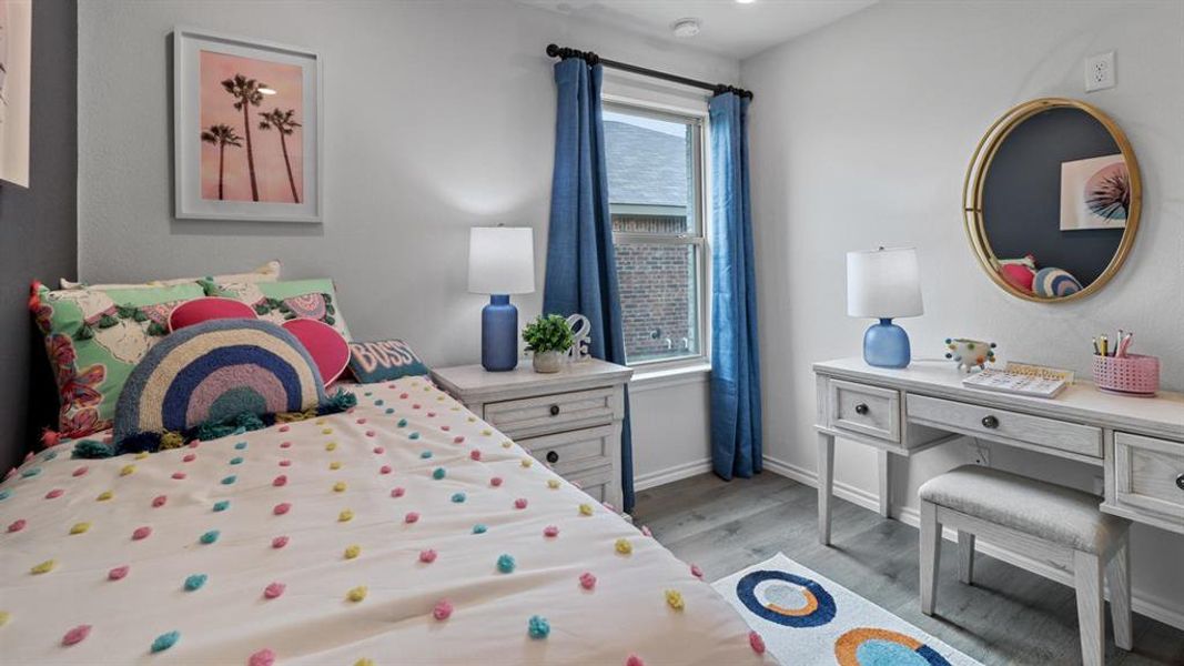 Bedroom featuring baseboards and light wood-style flooring Bedroom featuring baseboards and light wood-style flooring