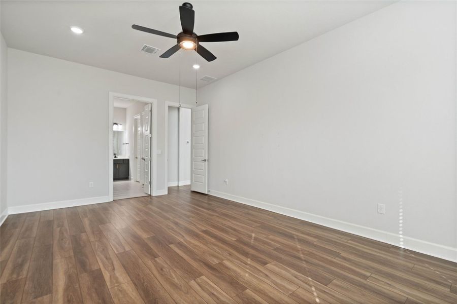 Warm wood flooring and clean white walls establish a serene, minimalist tone.