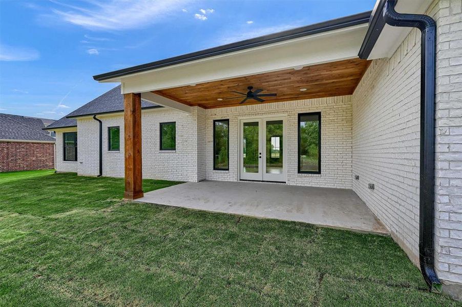 Back of house with a patio, a yard, and ceiling fan