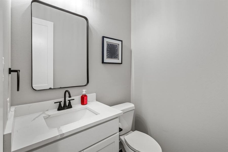 Bathroom featuring vanity and toilet