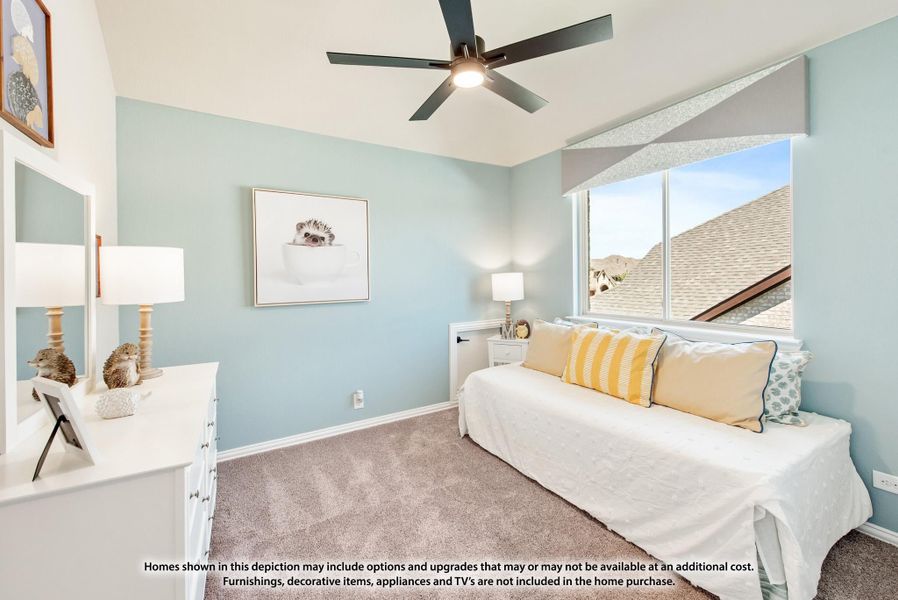 Bedroom with light blue walls, ceiling fan, carpet, and daybed with yellow accent pillows near a large window Bedroom with light blue walls, ceiling fan, carpet, and daybed with yellow accent pillows near a large window