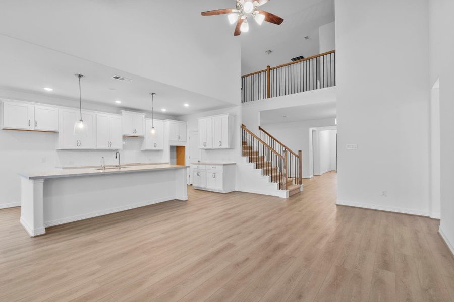 The two-story living room makes a striking statement, blending architectural drama with classic elegance.