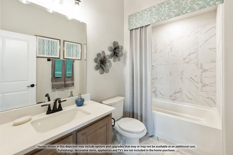 Bathroom with single vanity, white quartz countertop, and tub-shower combo with marble-look tile surround. Bathroom with single vanity, white quartz countertop, and tub-shower combo with marble-look tile surround.