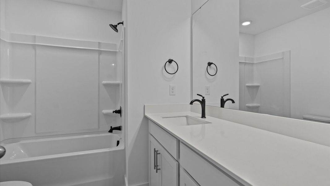 Memorable guest bath with refined tilework and a fresh, inviting feel Memorable guest bath with refined tilework and a fresh, inviting feel