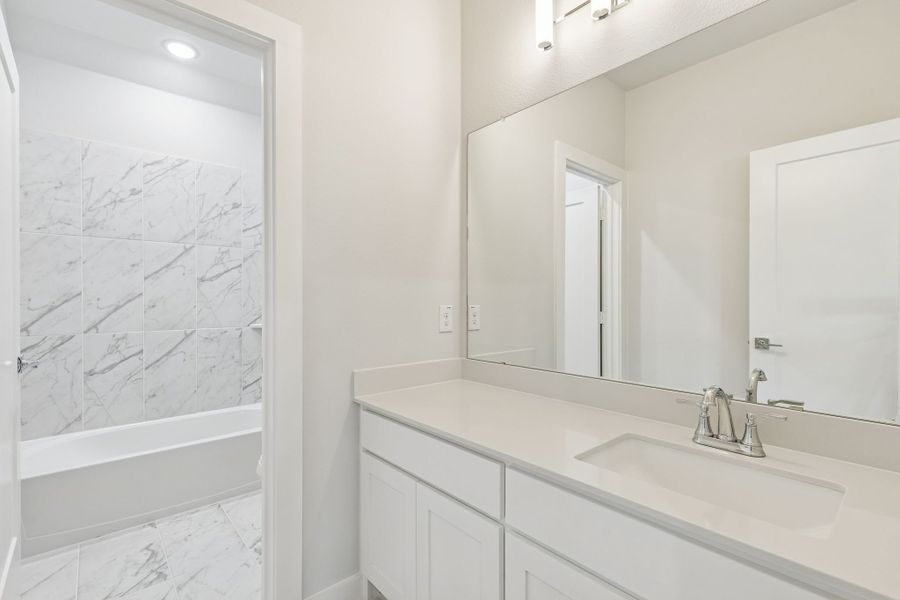 Bathroom in the Masters home plan by Trophy Signature Homes – REPRESENTATIVE PHOTO