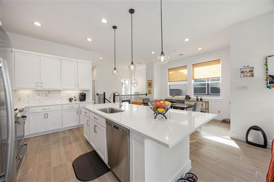 Sleek kitchen complete with stainless steel appliances, quartz countertops, and an under-mounted sink.