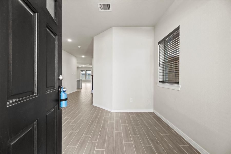 Wood look tile takes you through the home.