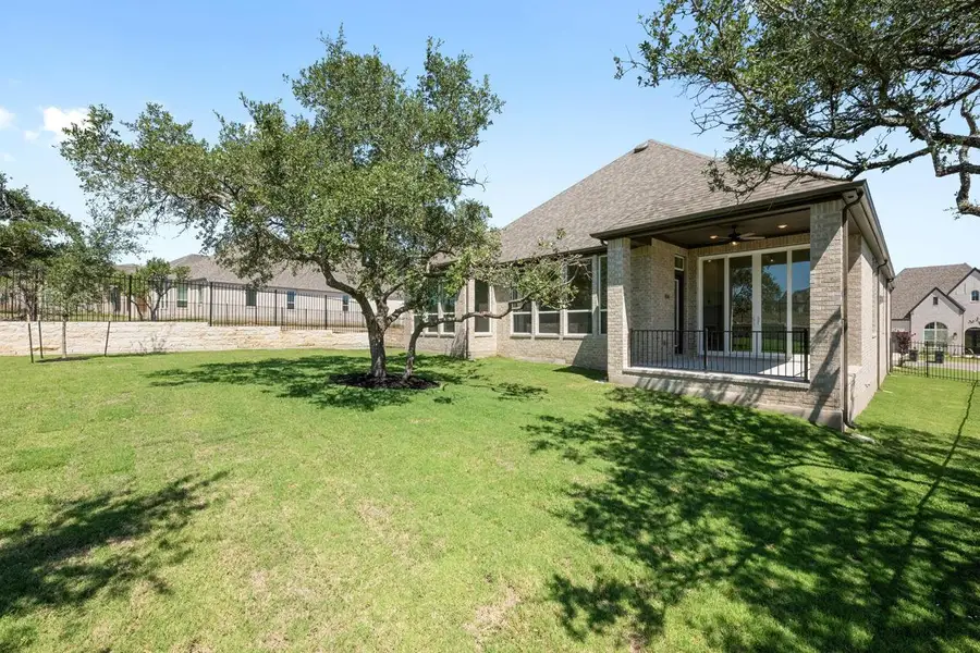 View of yard featuring a patio and a ceiling fan View of yard featuring a patio and a ceiling fan