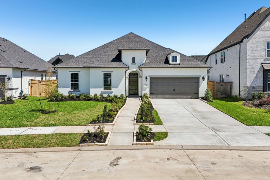 Front exterior of a new home in Sienna 65', Missouri City, TX, highlighting curb appeal (Image 20).