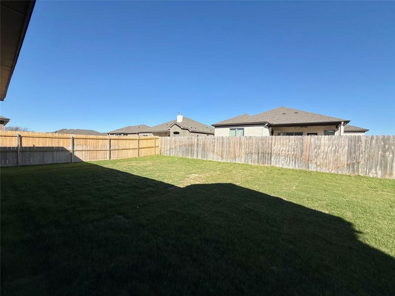 Fenced backyard with a residential view