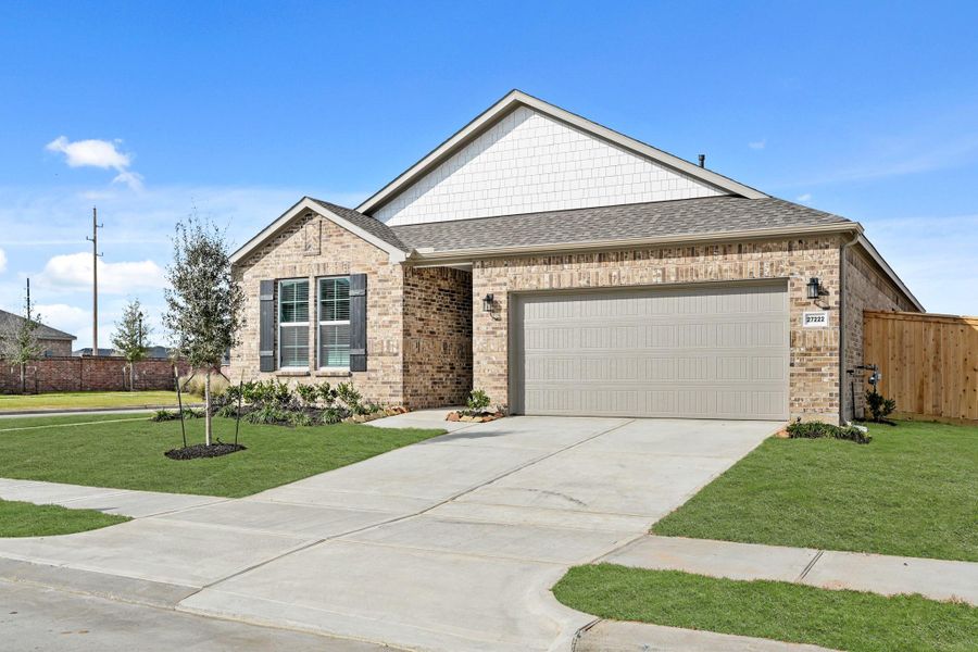 Front exterior of a new home in Sunterra, Katy, TX, highlighting curb appeal (Image 19).
