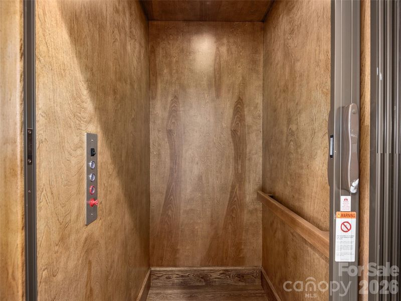 Private residential elevator with warm wood interior finish, providing convenient access between levels.