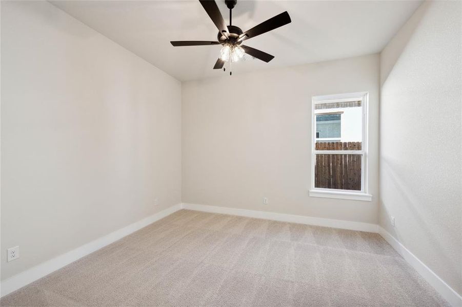 Unfurnished room with ceiling fan and light carpet