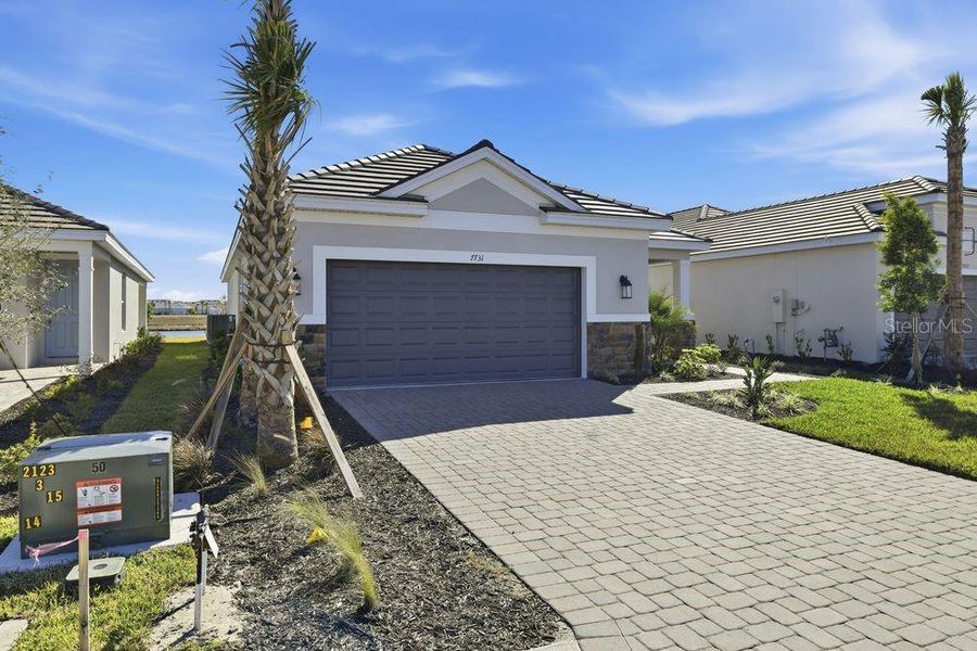 Front exterior of a new home in Coasterra Community Group Page, Palmetto, FL, highlighting curb appeal (Image 18).