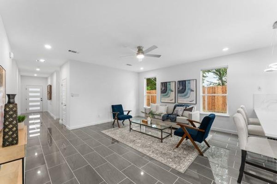 Living area featuring recessed lighting, plenty of natural light, and ceiling fan Living area featuring recessed lighting, plenty of natural light, and ceiling fan