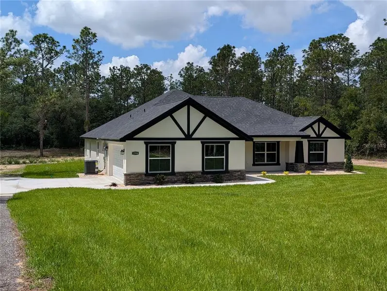 Front exterior of a new home in , Dunnellon, FL, highlighting curb appeal (Image 1). Front exterior of a new home in , Dunnellon, FL, highlighting curb appeal (Image 1).