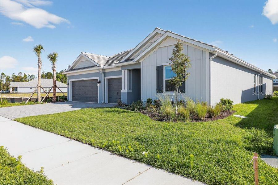 Front exterior of a new home in Hammock at Two Rivers, Zephyrhills, FL, highlighting curb appeal (Image 23).